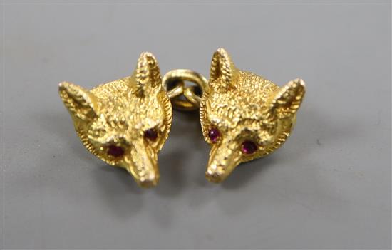 A 9ct gold fox mask single cufflink with inset ruby eyes